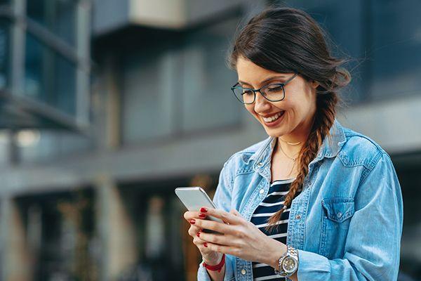 woman reading message on iphone