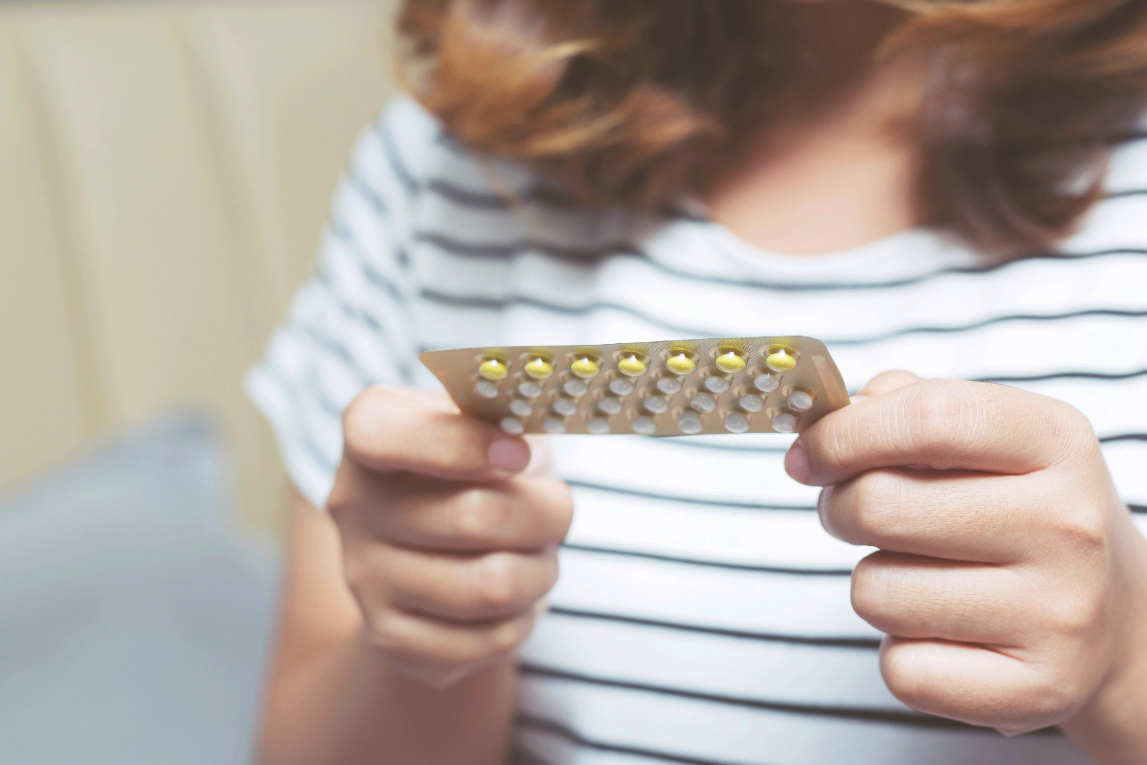 woman with birth control pills