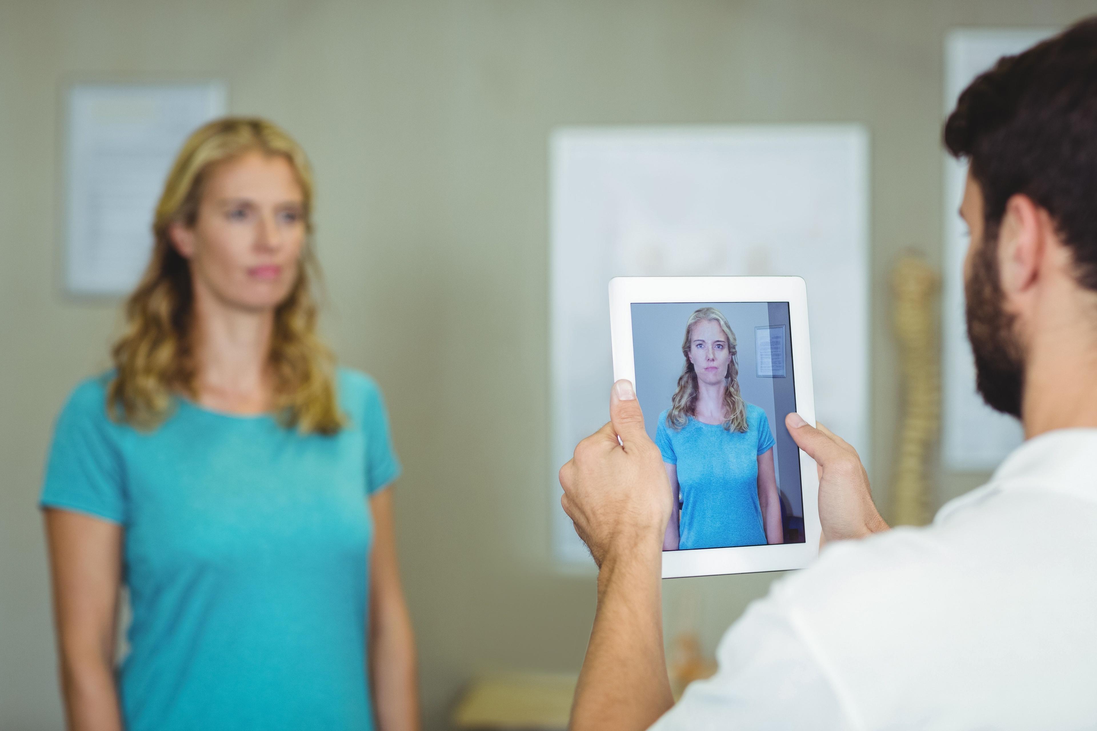 doctor taking picture of patient