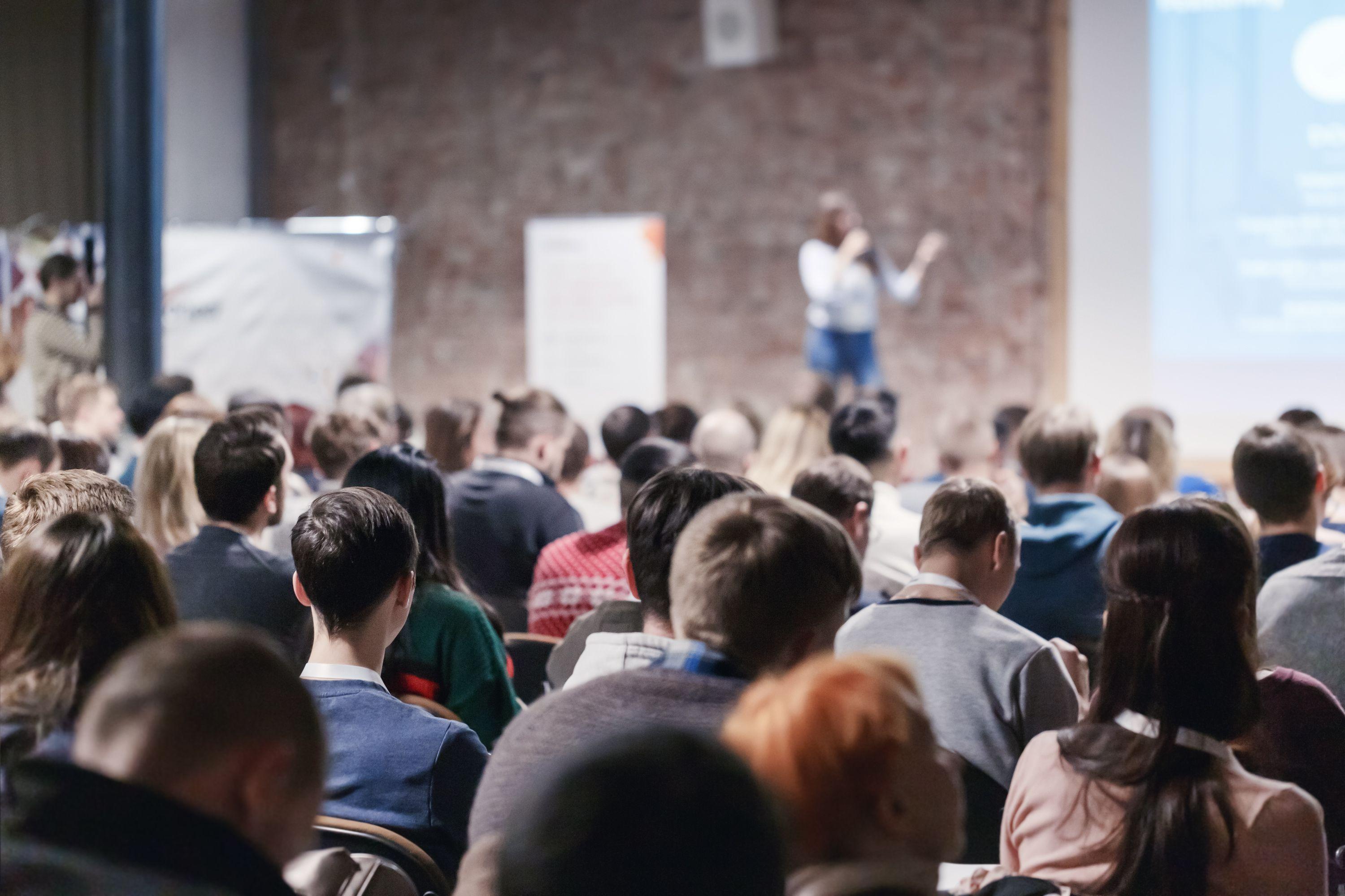 Presenter at conference giving speech