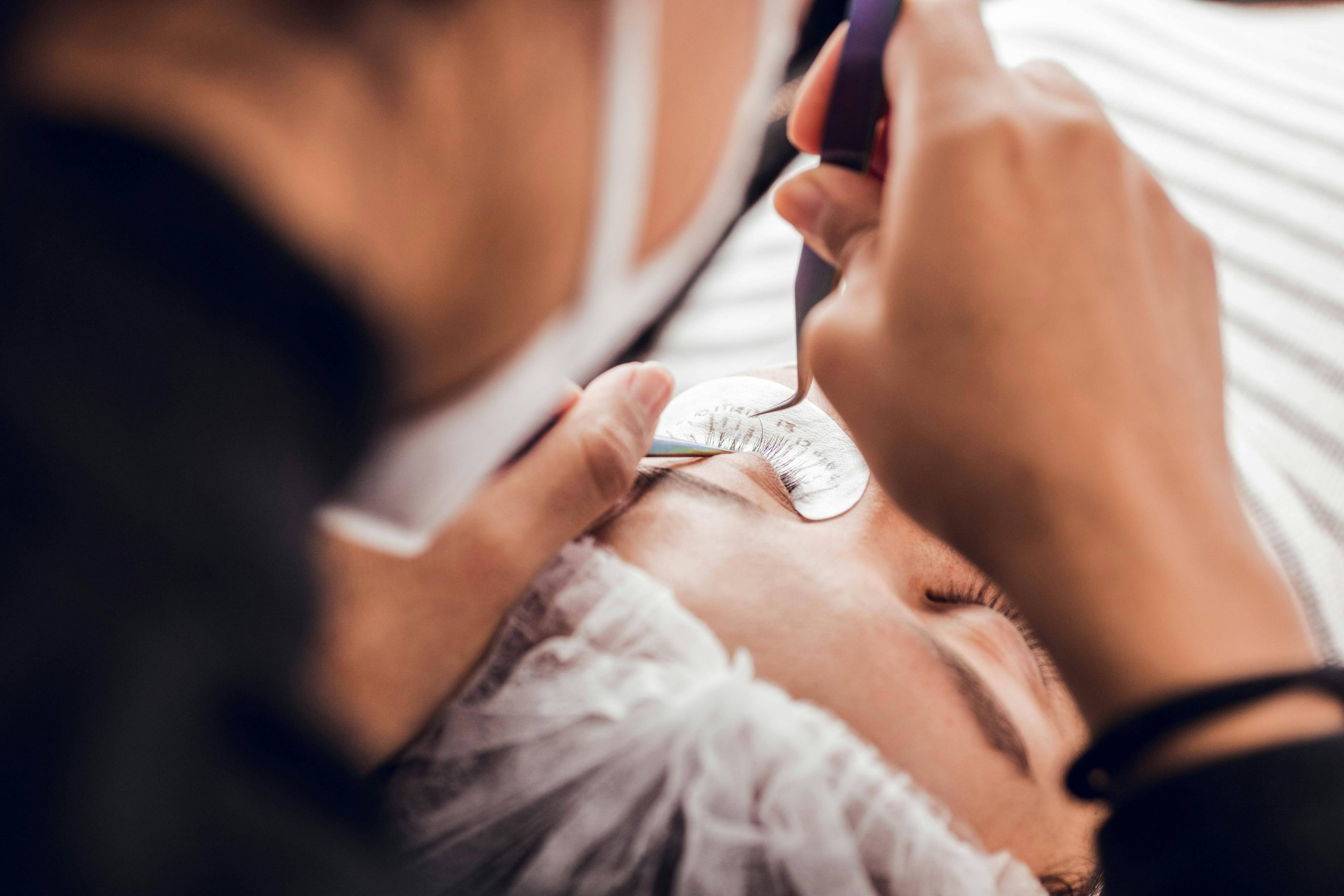 Applying false lashes to a patient | Image credit: © Leon Colon Ortega/Wirestock - stock.adobe.com